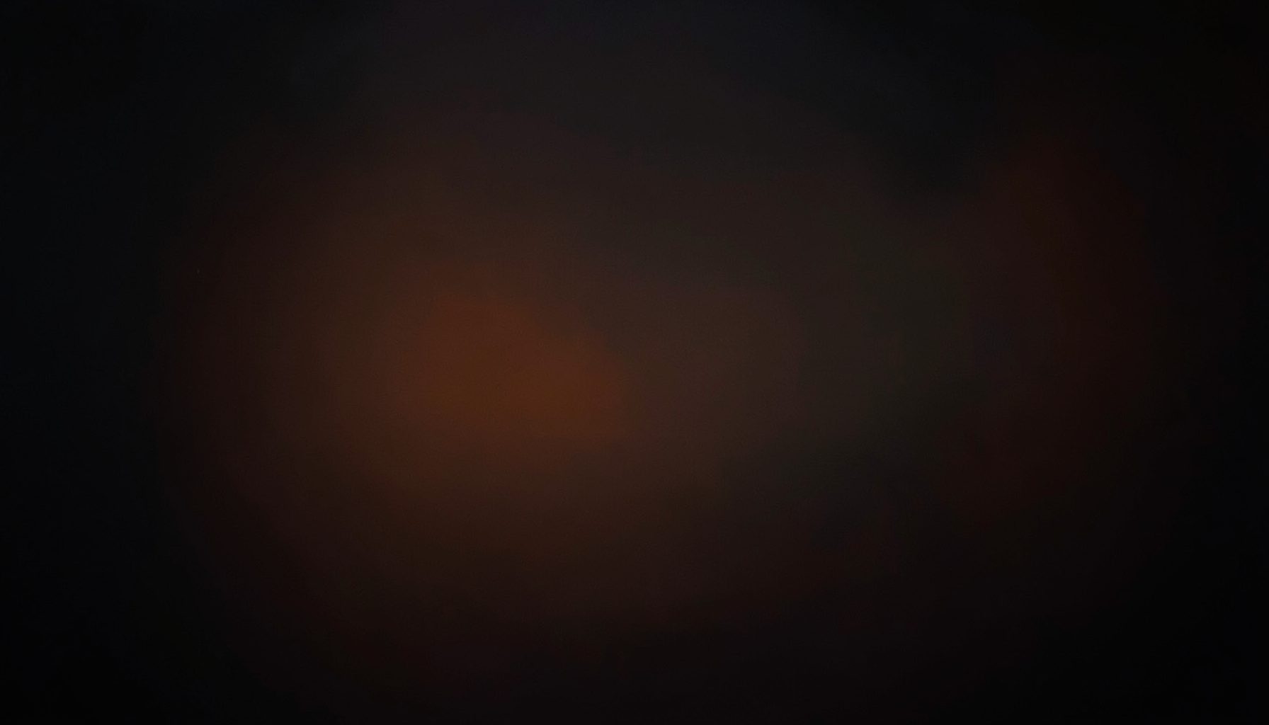 Abstract dark gradient with subtle orange highlights, conveying focus and strategic clarity